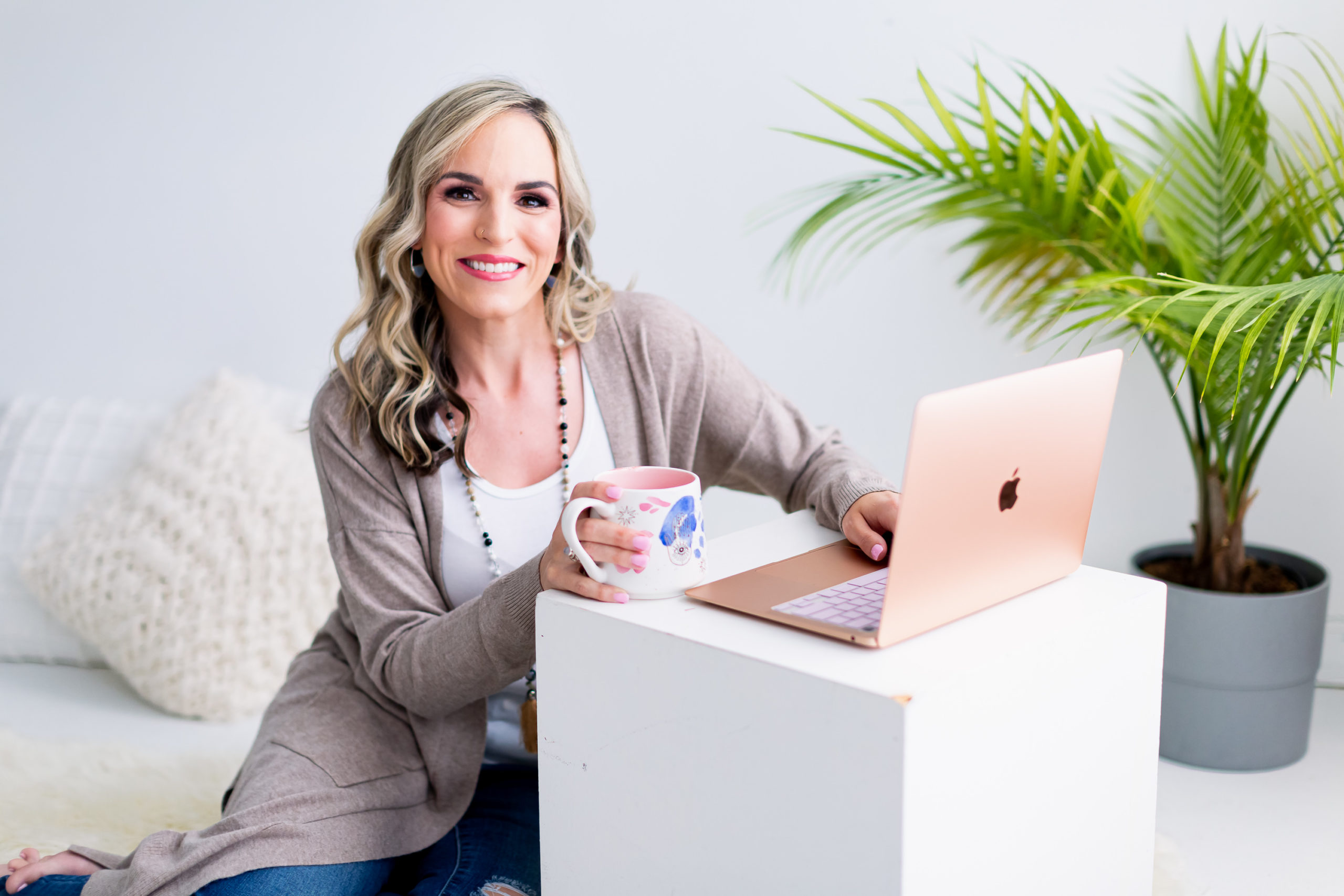 Smiling Woman Drinking Coffee and Typing on Computer