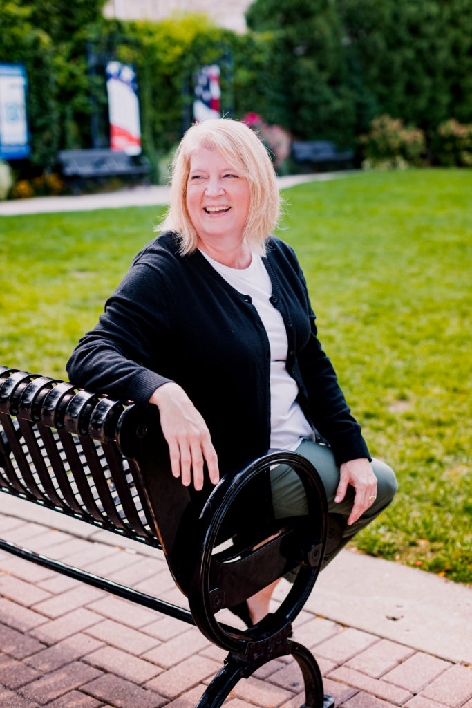 Woman in Casual Business Attire Sitting on Bench