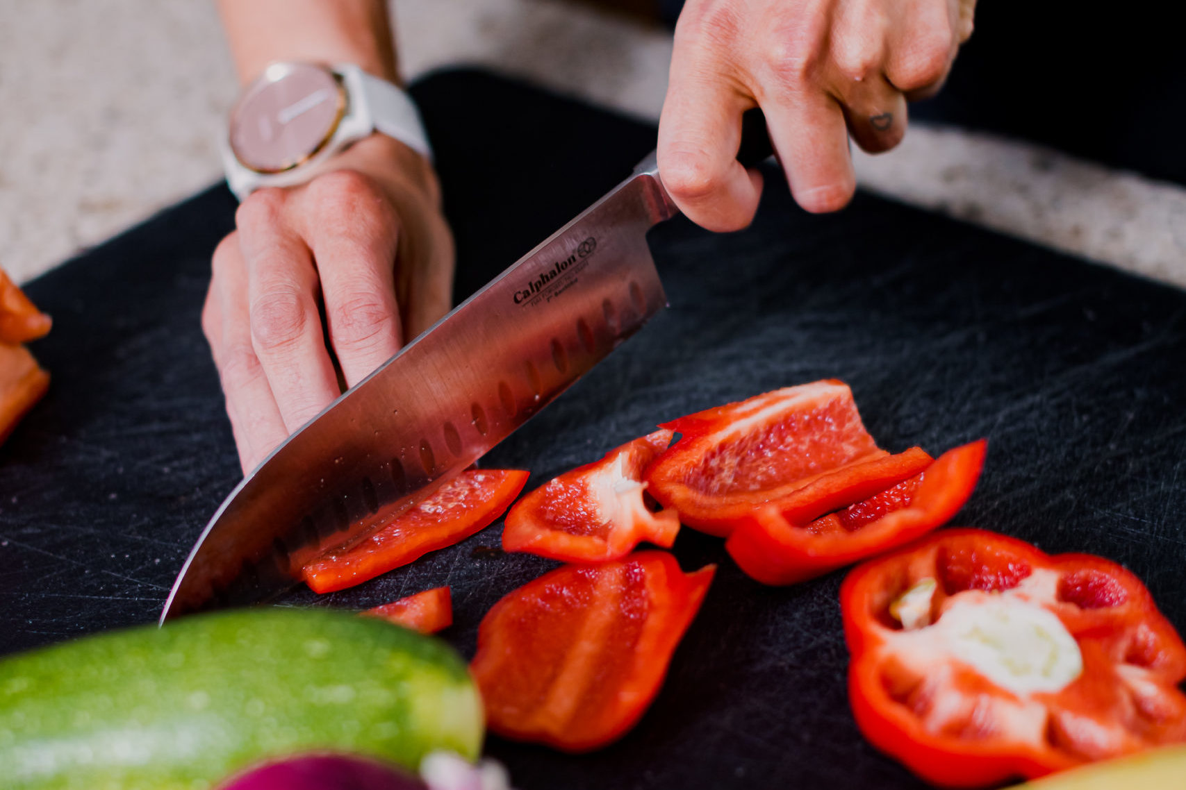 Woman Chopping Vegetables on Cutting Board