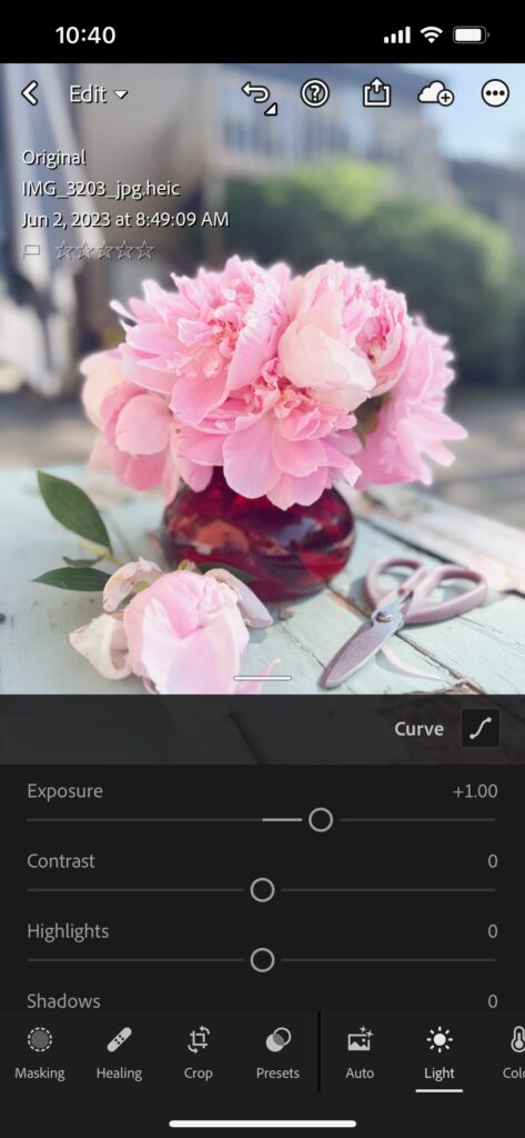 Screenshot of flower product photos being brightened in lightroom mobile app