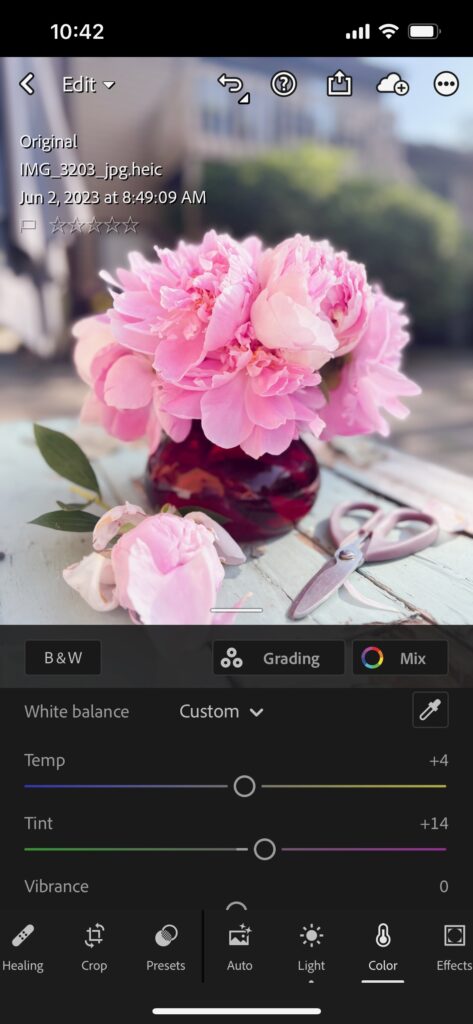 Screenshot of flower product photos being white balance adjusted in lightroom mobile app