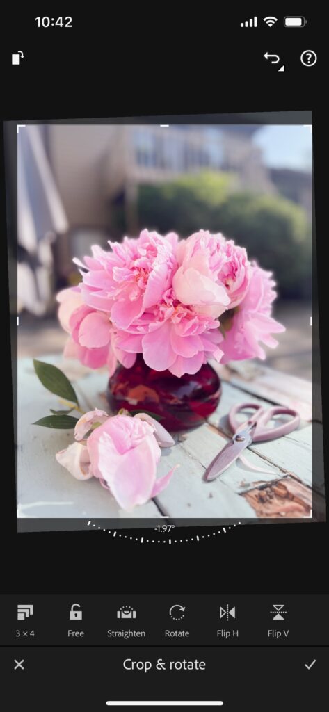Screenshot of flower product photos being straightened in lightroom mobile app