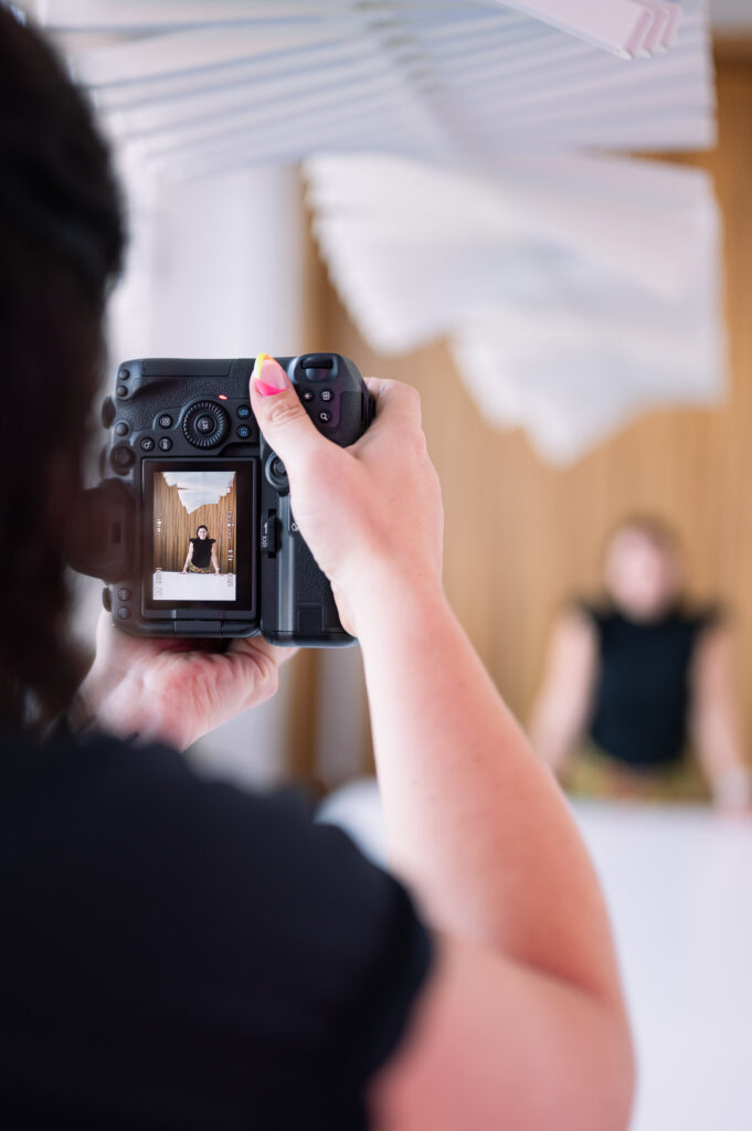perspective photo of the back of the camera that a photographer sees while taking a branding photo