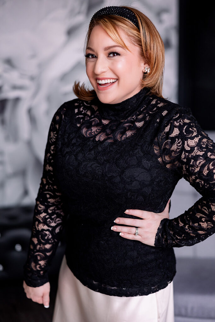 Vibrant brand photo of a woman smiling in a black lace dress, taken by This Way to Fabulous