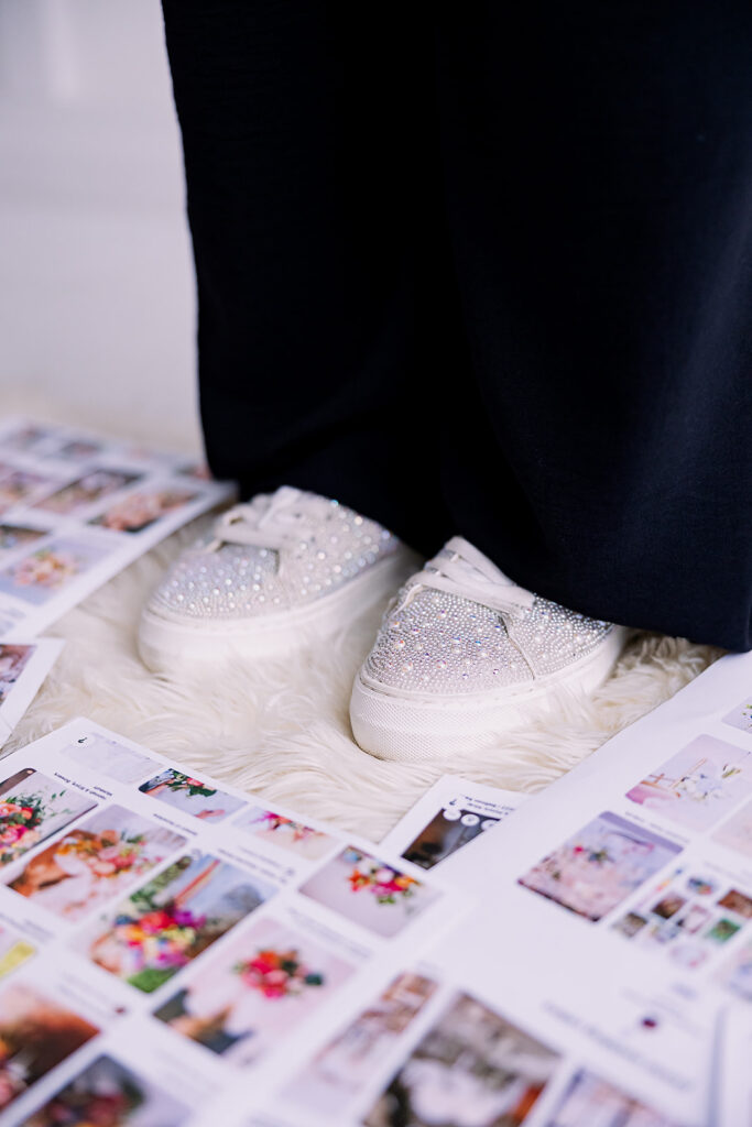 Vibrant and fun brand photo of a woman's sparkly white sneakers standing surrounded by mood boards, taken by This Way to Fabulous