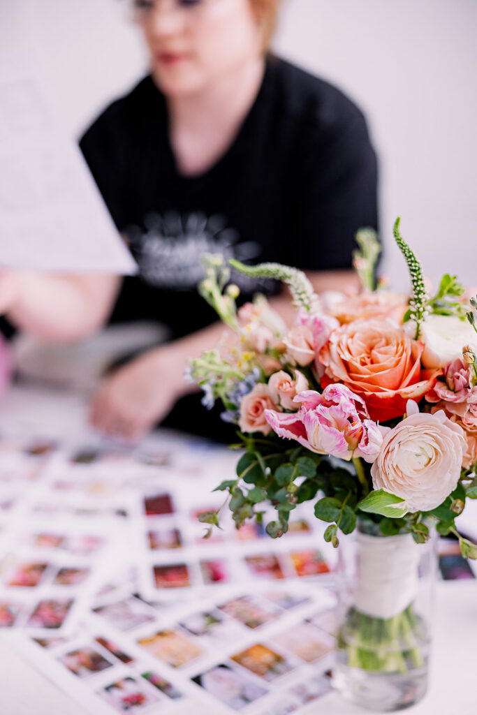 Vibrant and fun brand photo of a woman sitting surrounded by flowers, balloons, and mood boards, taken by This Way to Fabulous