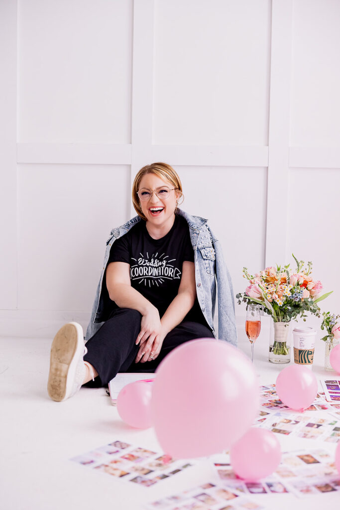 Vibrant and fun brand photo of a woman sitting surrounded by flowers, balloons, and mood boards, taken by This Way to Fabulous