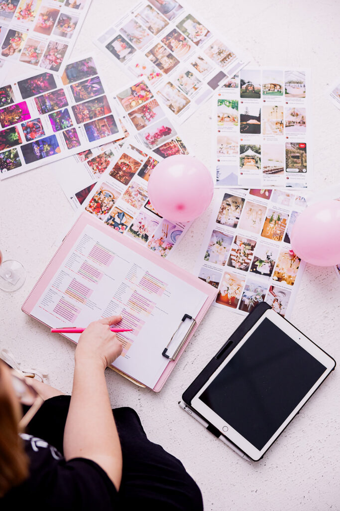 Vibrant and fun brand photo of a woman sitting surrounded by checklists, a tablet, balloons, and mood boards, taken by This Way to Fabulous