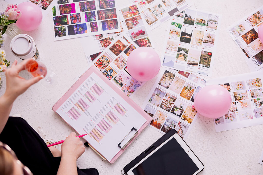 Vibrant and fun brand photo of a woman writing in a notepad surrounded by colorful mood boards, taken by This Way to Fabulous