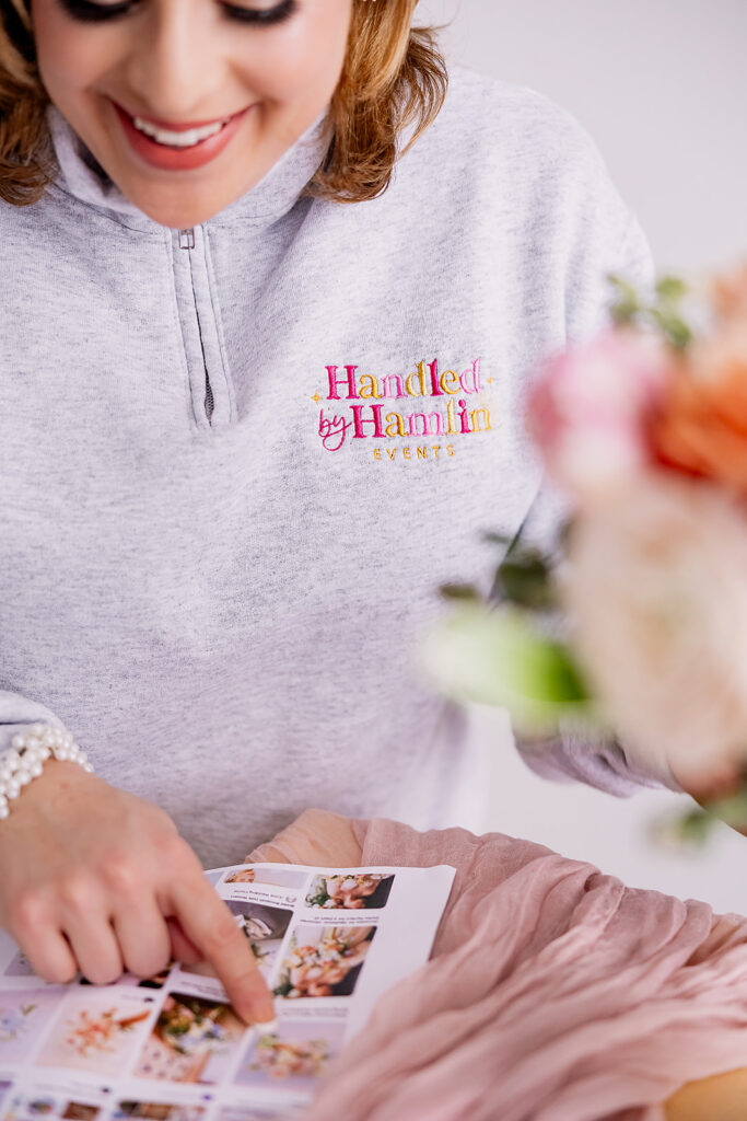 Vibrant and fun brand photo of a woman pointing at a mood board, taken by This Way to Fabulous