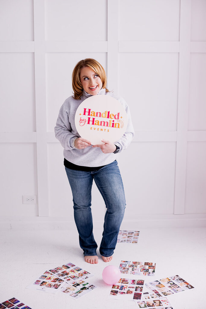 Vibrant and fun brand photo of a woman holding a logo sign, taken by This Way to Fabulous