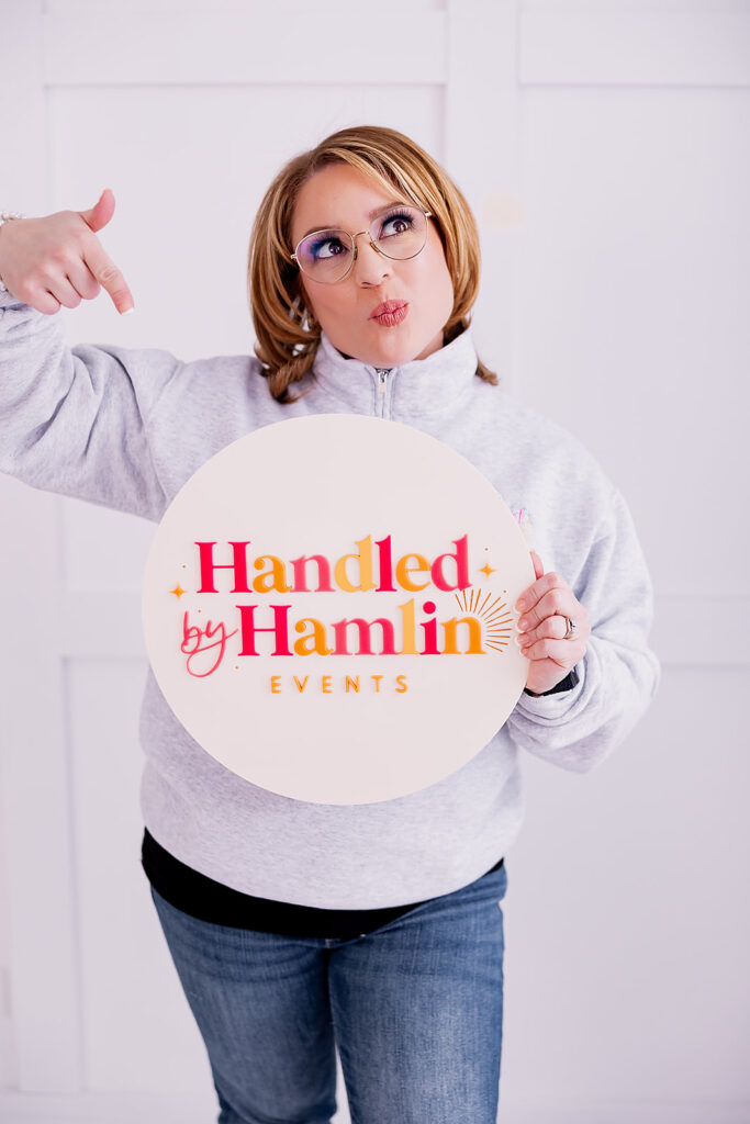 Vibrant and fun brand photo of a woman holding a logo sign, taken by This Way to Fabulous