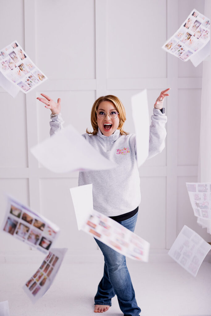 woman throwing papers in the air and smiling
