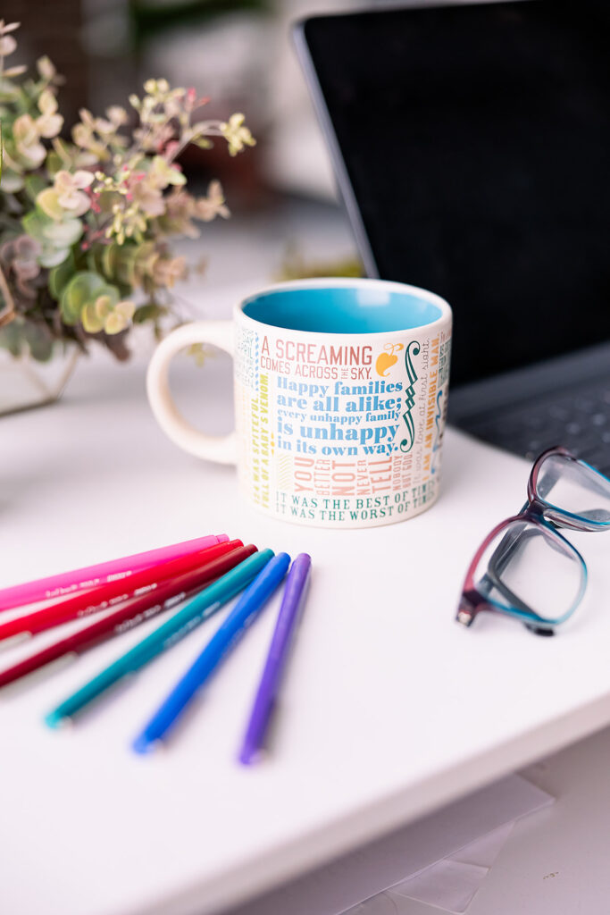 mug and colorful pens on a desk