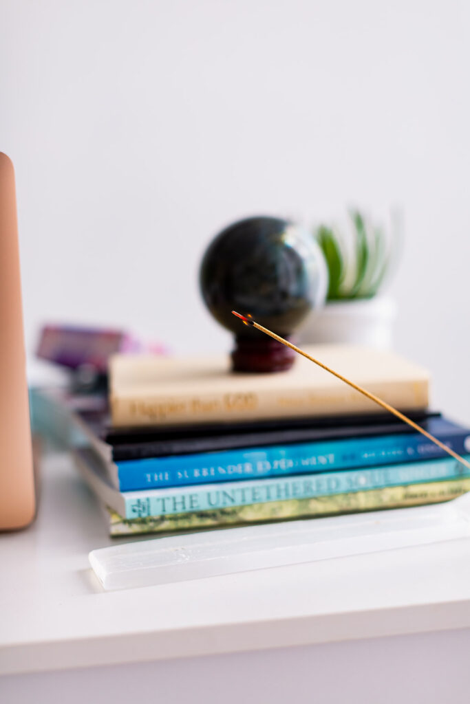 books and an incense stick on a desk