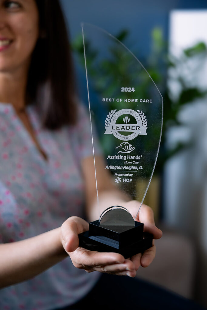 woman holding award for best of home care