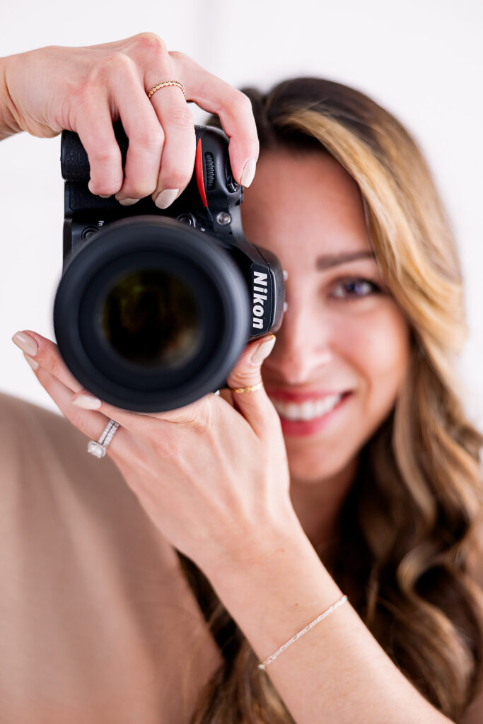 photographer holding her camera up close to the camera