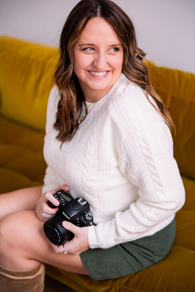 photographer headshot sitting on a yellow couch
