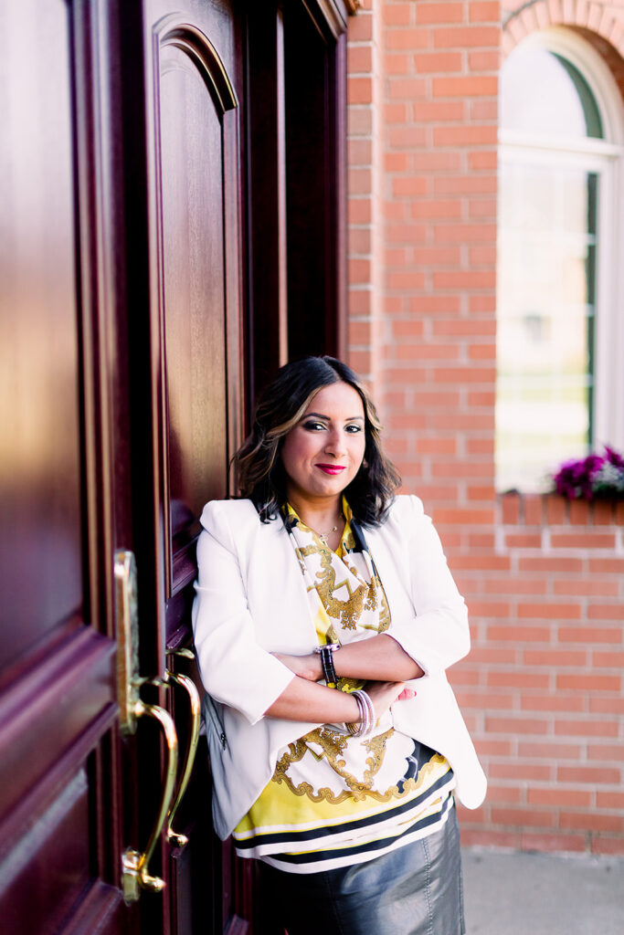 real estate agent leaning against an opulent wooden door