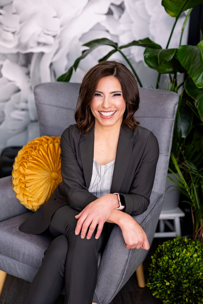 a woman dressed in professional clothing posing for a headshot