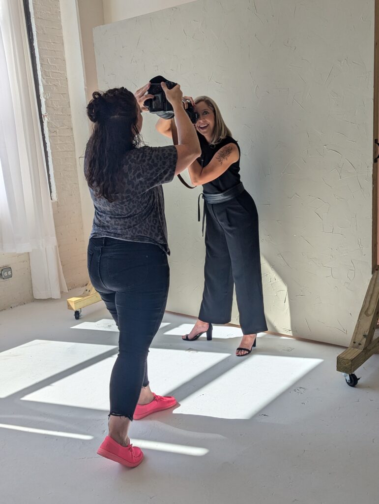 two photographers taking photos of each other during a branding photoshoot