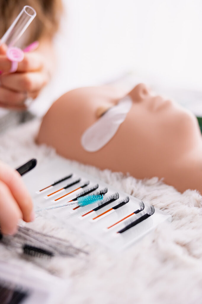 Branding detail image of lash extension brushes and tools near a dummy face