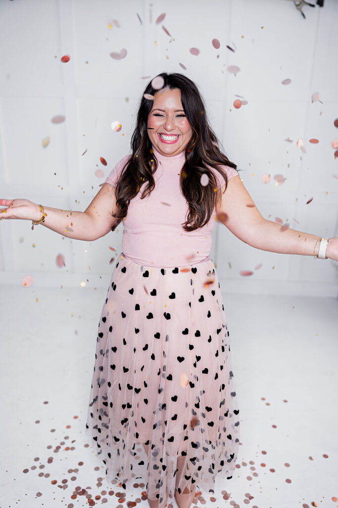 personal branding photo of Jacquelin Castillo of Mom Like a Boss wearing light pink throwing confetti photographed by This Way to Fabulous