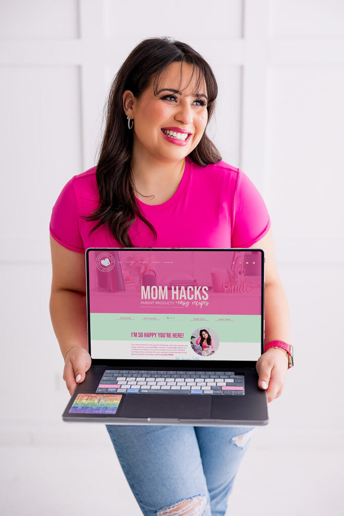 personal branding photo of Jacquelin Castillo of Mom Like a Boss holding a laptop showing her website, photographed by This Way to Fabulous
