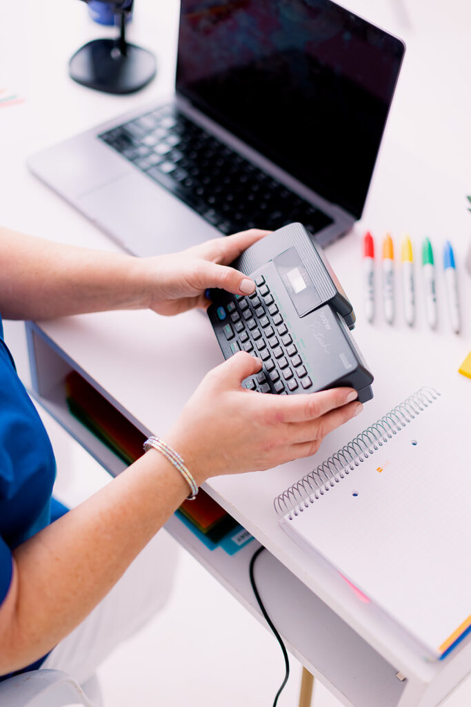Brightly colored office supplies and a label maker at a professional organizer branding photoshoot by This Way to Fabulous