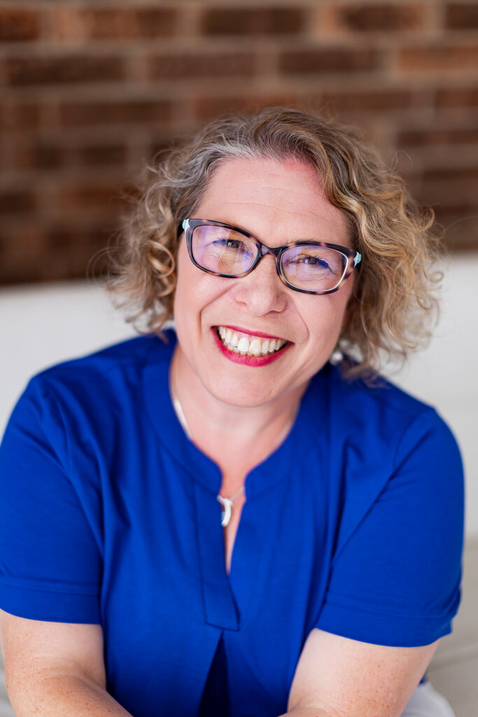 Amy from Clutter Care smiling at the camera during her professional organizer branding photoshoot by This Way to Fabulous