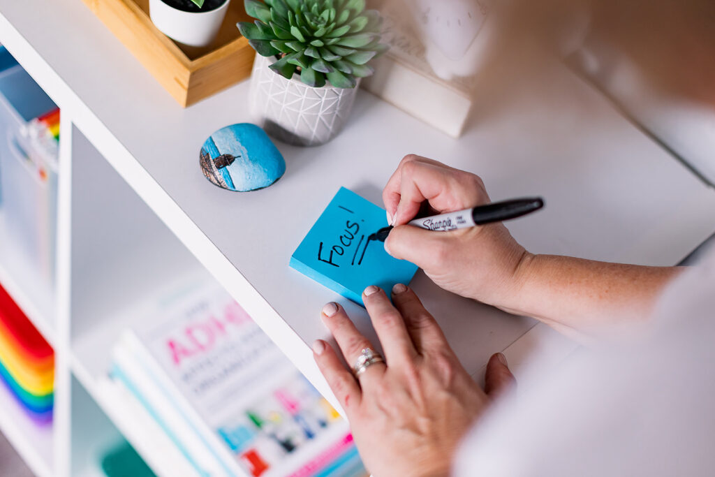 Brightly colored post it note with "Focus!" written on it in Google Educator colors at a professional organizer branding photoshoot by This Way to Fabulous